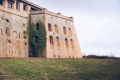 Low angle view of old ruin against sky