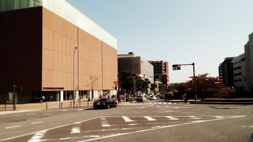 Vehicles on road against buildings in city