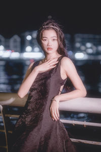 Portrait of young woman sitting on chair