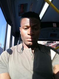 Portrait of young man in bus