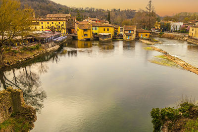 High angle view of valeggio sul mincio with the buildings reflecting on the water