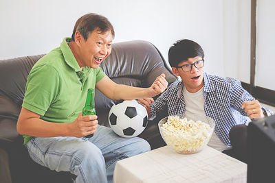 Men watching soccer match on tv