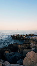 Scenic view of sea against clear sky during sunset