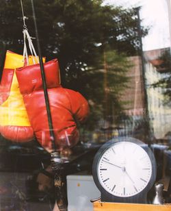 Boxing gloves and clock at store window