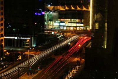 Light trails on road along buildings at night