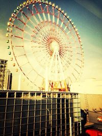 Low angle view of ferris wheel against sky