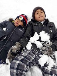 Full length of a smiling girl with snow during winter