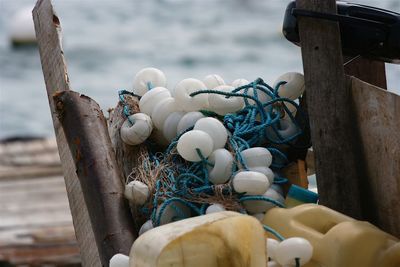 Close-up of fishing net on boat at harbor