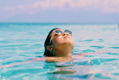 Portrait of woman swimming in sea