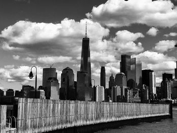 View of cityscape against cloudy sky