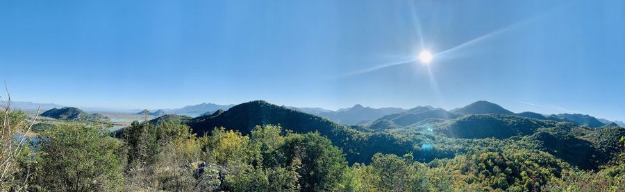 Scenic view of mountains against blue sky