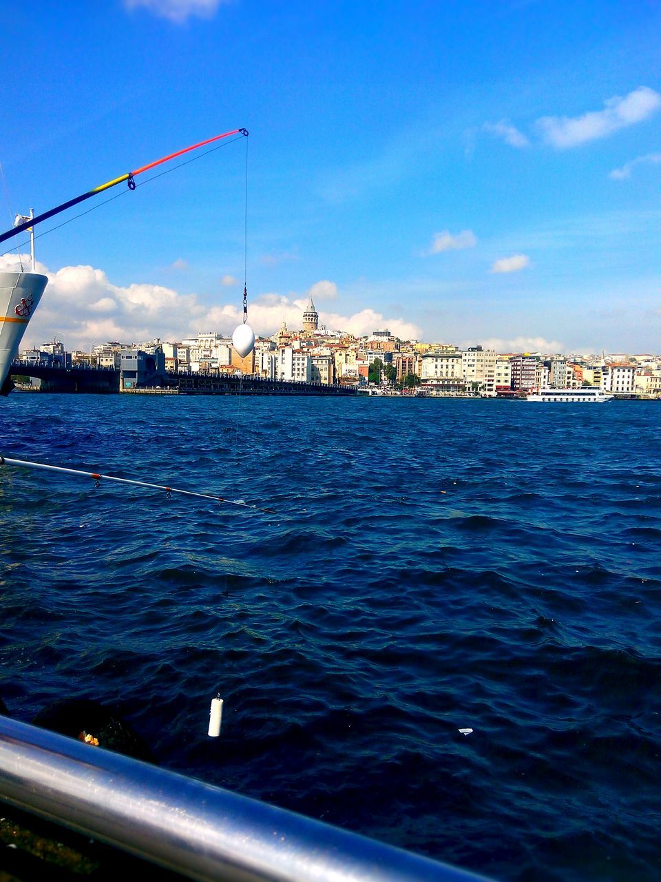 water, built structure, architecture, sea, blue, sky, connection, building exterior, waterfront, river, bridge - man made structure, rippled, railing, transportation, nautical vessel, pier, harbor, city, outdoors, bridge