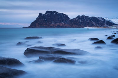 Scenic view of sea and rocks against sky