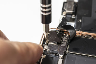 Close-up of hand holding sewing machine