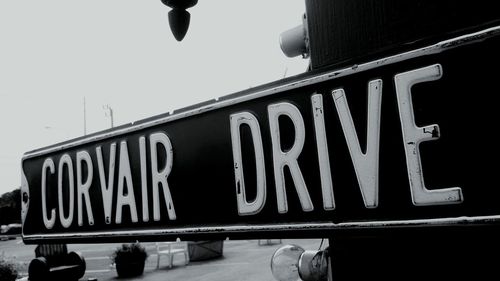 Low angle view of road sign against clear sky