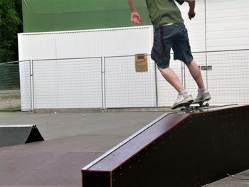 Low section of man skateboarding on skateboard