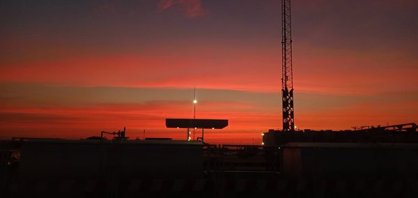 Silhouette of building against dramatic sky during sunset
