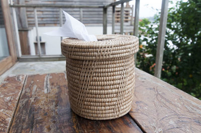 Close-up of wicker tissue paper container on table