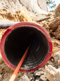 Close-up of red pipe on rock