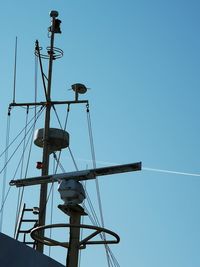 Low angle view of crane against clear sky