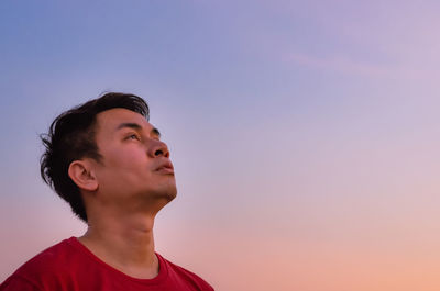 Asian man looking up to sky. emotion face expression.