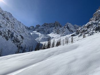 Scenic view of snow covered mountains against sky