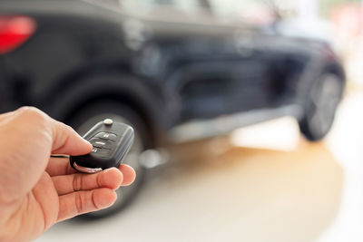 Close-up of person hand holding car