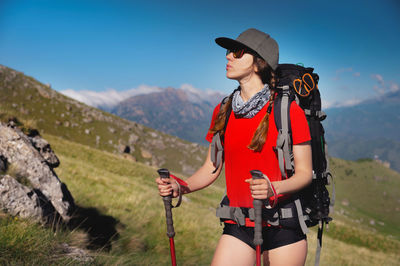 Woman tourist young caucasian walking uphill on a sunny day under sunlight. nice view of the