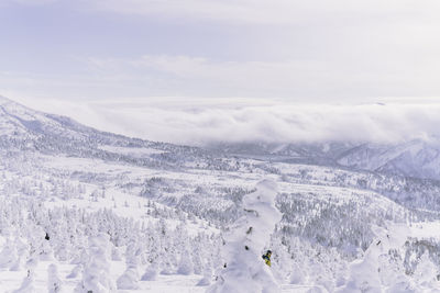 Scenic view of snow covered mountains against sky