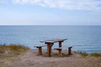 Gazebo on table by sea against sky