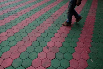 Low section of man walking on road