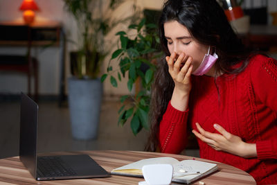 Sick woman sitting at home