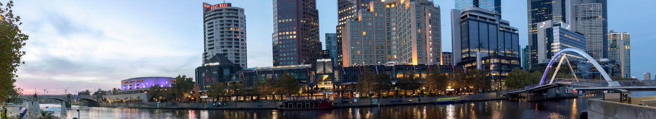 Panoramic view of bridge and buildings against sky