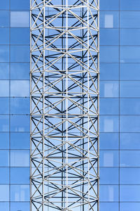 Low angle view of modern building against blue sky