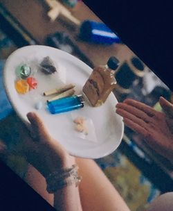 High angle view of hand holding ice cream on table