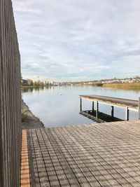 Pier on lake against sky