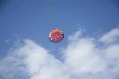 Low angle view of balloons flying against sky