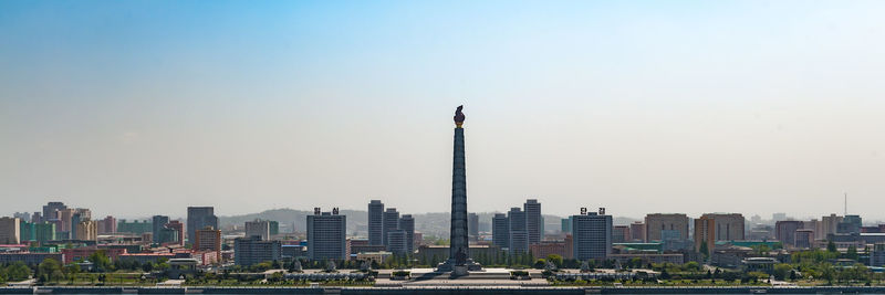 View of buildings in city against clear sky