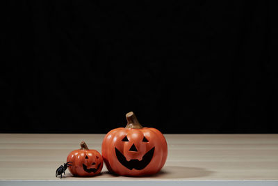 Close-up of pumpkin on table against black background