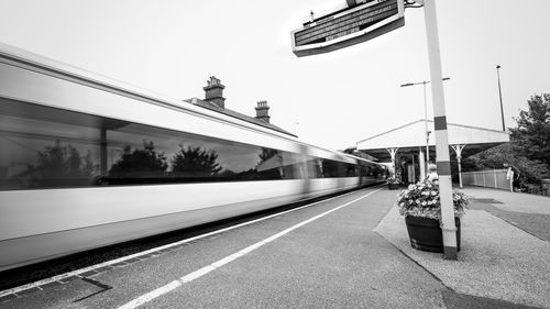 Train at railroad station against sky