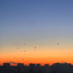 Silhouette of buildings against sky during sunset
