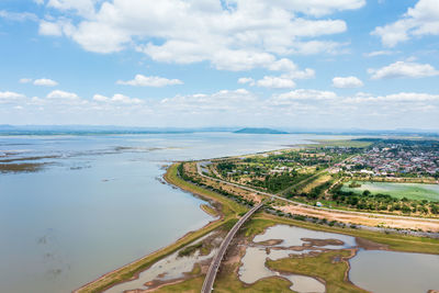 Aerial view of the railway bridge over a reservoir and community near pasak chonlasit dam 