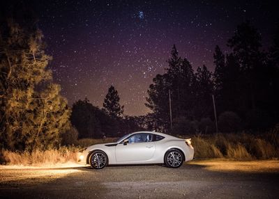 Car on country road against sky at night