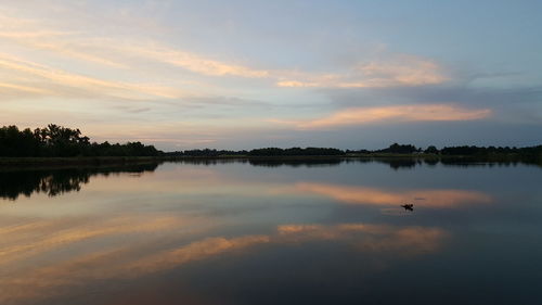 Scenic view of calm lake at sunset