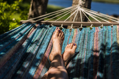 Low section of man relaxing on hammock