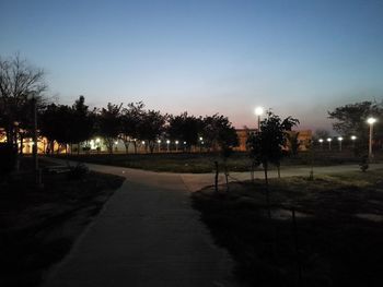 Illuminated street light against clear sky at night