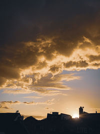 Low angle view of silhouette buildings against sky during sunset