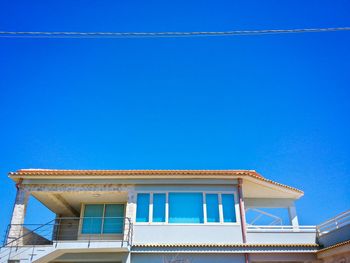 Low angle view of built structure against clear blue sky