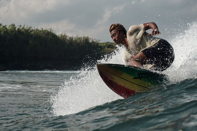 Man surfing on boat in sea