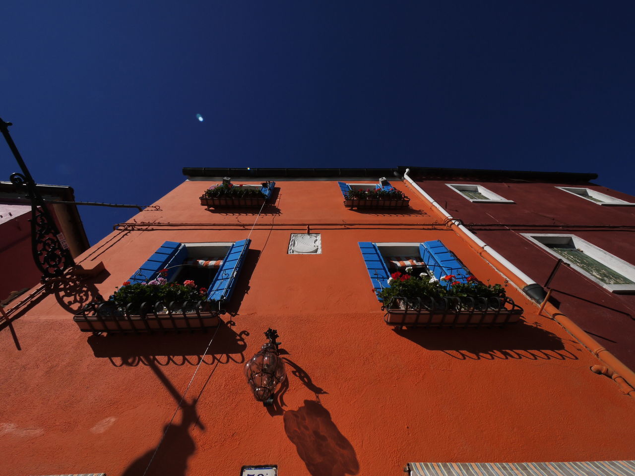 LOW ANGLE VIEW OF BUILDING AGAINST BLUE SKY AT NIGHT